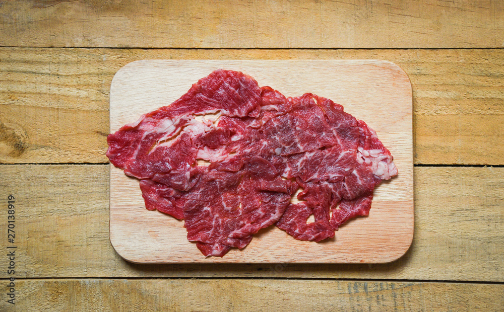 Meat beef slice on wooden cutting board for cooked or Sukiyaki Shabu shabu Japanese foods Asian