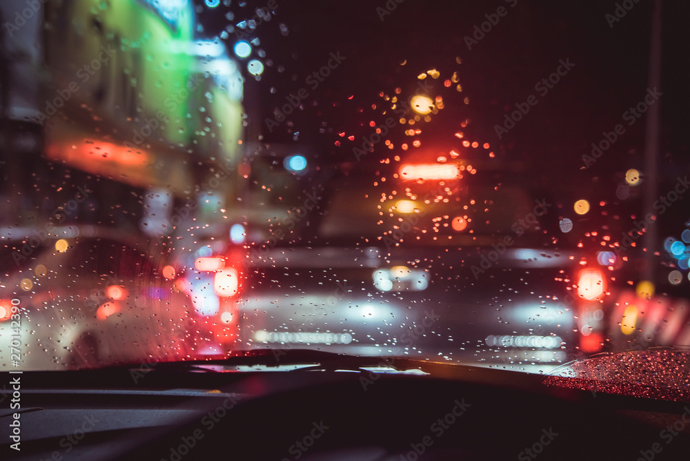 people driving car night time with raindrop. people driving car night time with raindrop.