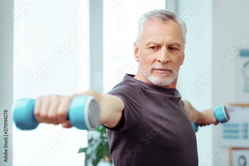 Strong well built man enjoying his training