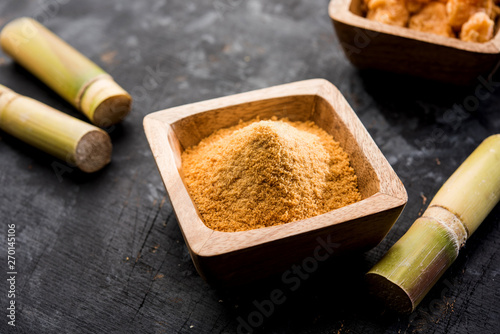 Organic Gur or Jggery Powder is unrefined sugar obtained from concentrated sugarcane juice. served in a bowl. selective focus