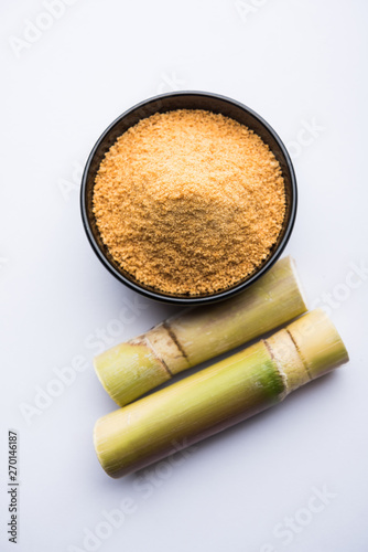 Organic Gur or Jggery Powder is unrefined sugar obtained from concentrated sugarcane juice. served in a bowl. selective focus