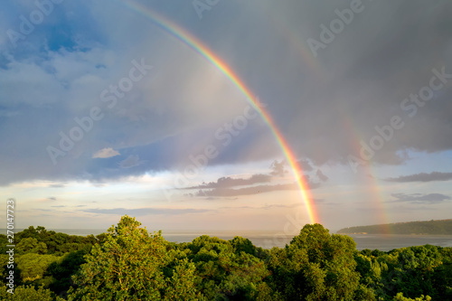 Fototapeta Naklejka Na Ścianę i Meble -  Stunning two big rainbows after the rain over the sea