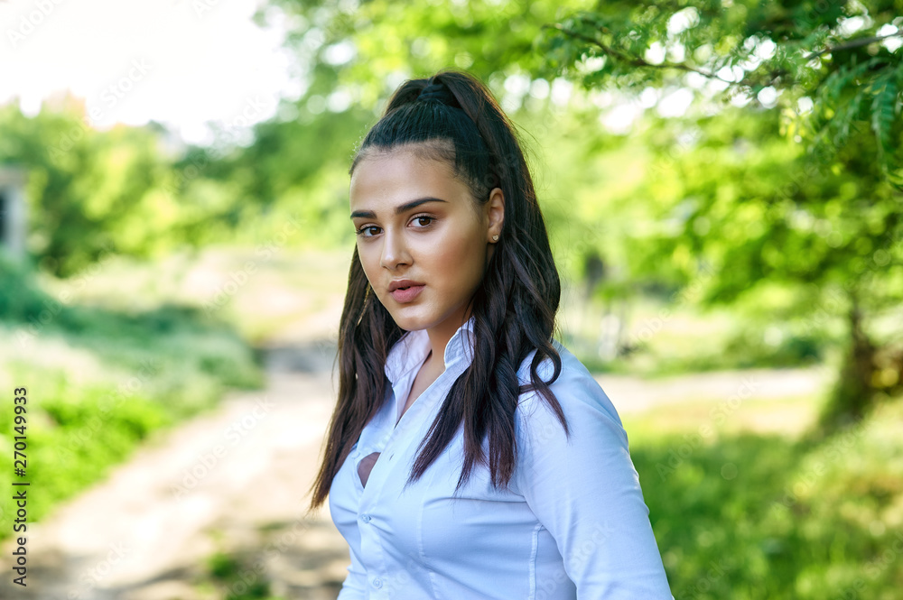 Portrait of a young girl Eastern appearance . Model in light shirt Portrait of a young girl Eastern appearance . Model in light shirt