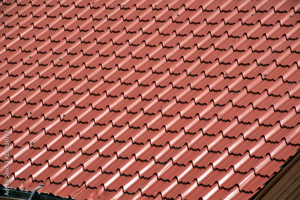 Abstract background texture, architectural details,brown ceramic roof tiles in seamless diagonal pattern on sunny day.
