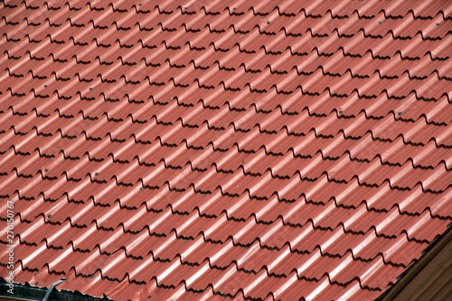 Abstract background texture  architectural details brown ceramic roof tiles in seamless diagonal pattern on sunny day.