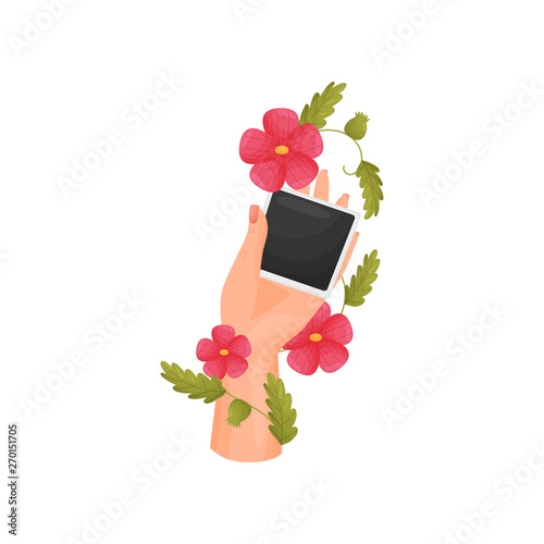 Photo poloroid in hand, decorated with flowers. Vector illustration on white background.