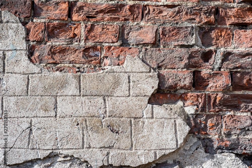 Fototapeta premium Broken surface of old brick wall