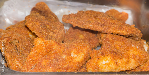 Freshly Cooked Southern Fried Fish:  Freshly cooked southern fried fish ready to be served at a restaurant deli. 