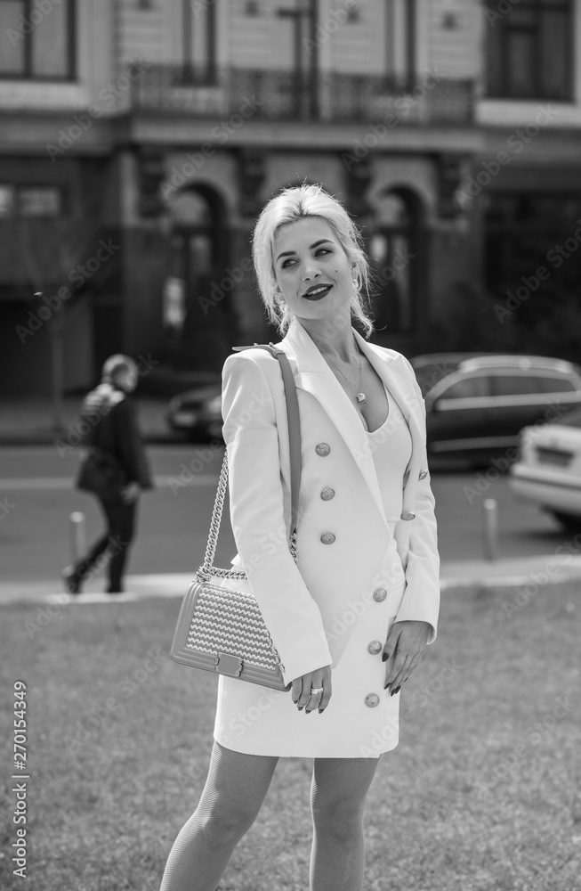 Luxurious woman in white suit at city. White dress code for lady. Fashionable business clothes Luxurious woman in white suit at city. White dress code for lady. Fashionable business clothes