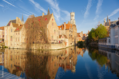 Rozenhoedkaai canal (Quai of the Rosary), and Belfort van Brugge’s Belfry Tower. Typical view of Bruges (Brugge), Belgium.