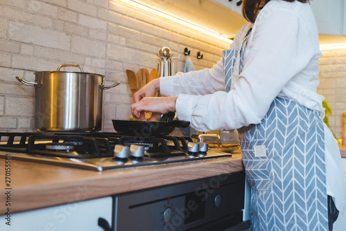 woman fry on pan kitchen view