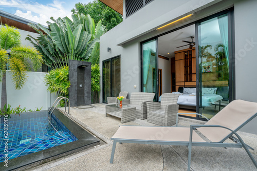 home or house building Exterior and interior design showing tropical pool villa with green garden © Stock PK