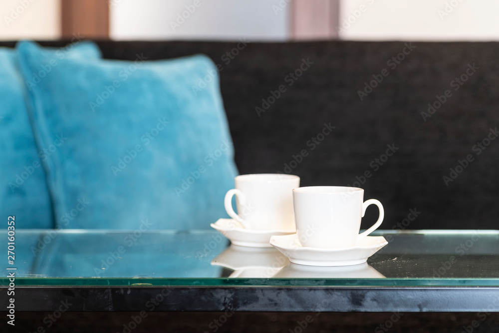 Two white coffee cups placed on the reception table in the living room