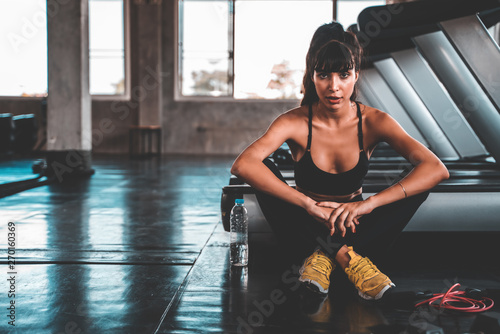 young fitness woman execute exercise with exercise-machine in gym.