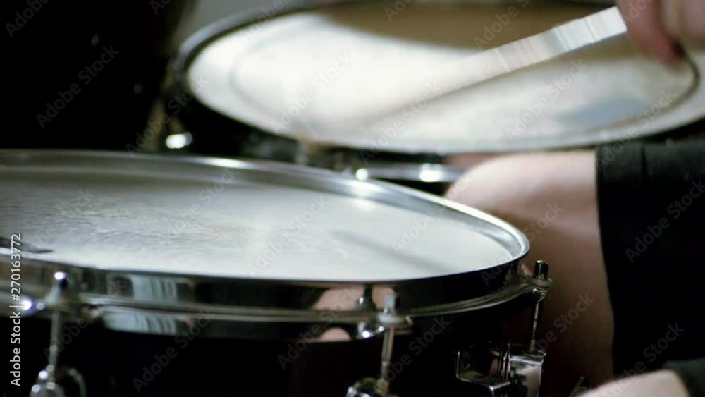 Musical band. Group of musicians playing rock music on stage. Close-up shot of drummer playing the drums by hitting it with sticks. Slow motion. HD Musical band. Group of musicians playing rock music on stage. Close-up shot of drummer playing the drums by hitting it with sticks. Slow motion. HD