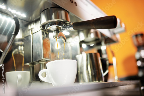Close-up of process of making cappuccino with coffee machine in cafe