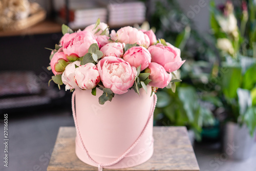 Fototapeta Naklejka Na Ścianę i Meble -  Pink peonies on the old grey table. Beautiful peony flower for catalog or online store. Floral shop concept . Beautiful fresh cut bouquet. Flowers delivery