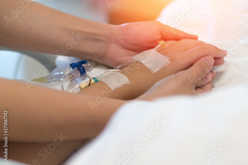 Chemo with cancer in child patient concept.Asian sick kid inpatient on hospital bed with pediatrician doctor exam with IV for chemotherapy in clinical healthcare.