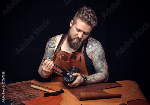 Leather Artist produces a good product at his tanning shop photo