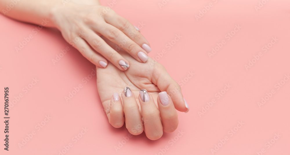 Naklejka premium Beautiful young woman's hand with perfect manicure on pink background. Flat lay style.