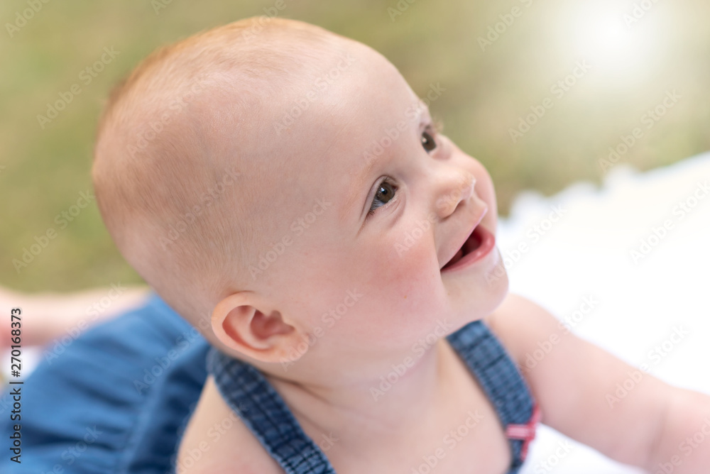 Portrait of cute smiling baby girl, outdoors, light effect Portrait of cute smiling baby girl, outdoors, light effect
