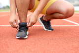 barefoot running shoes close up. male athlete tying laces shoelace for jogging on road concrete floor. Runner ties getting ready for training. Sport lifestyle.
