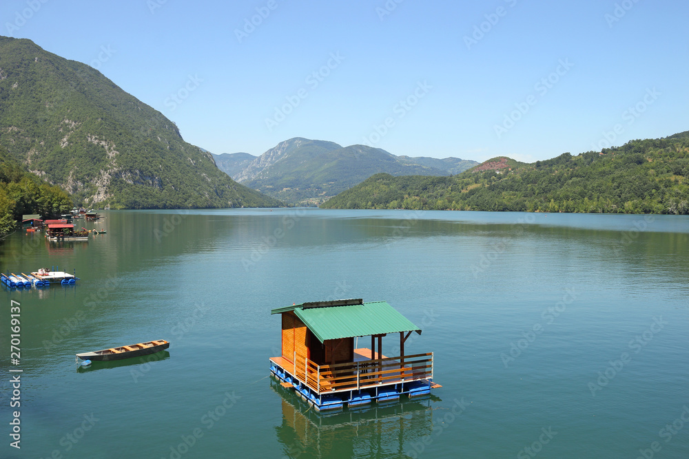 Small wooden house floating on Drina river Serbia