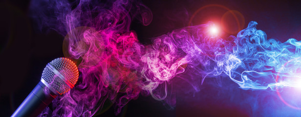 microphone and colorful smoke swirls on black background