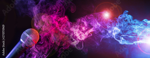 microphone and colorful smoke swirls on black background