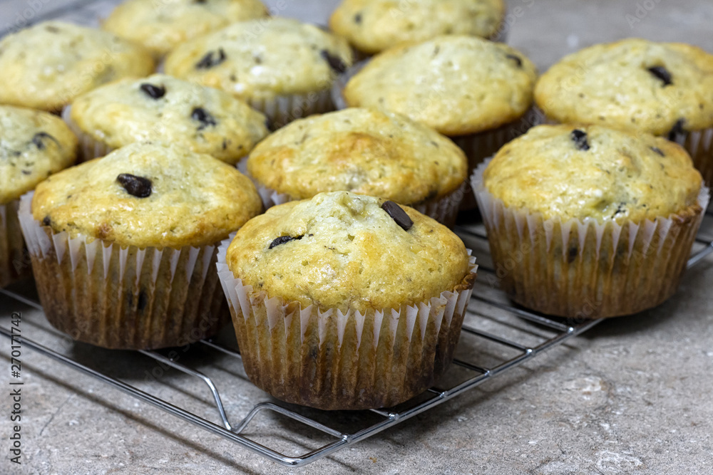 Chocolate chip muffins cooling on a wire rack