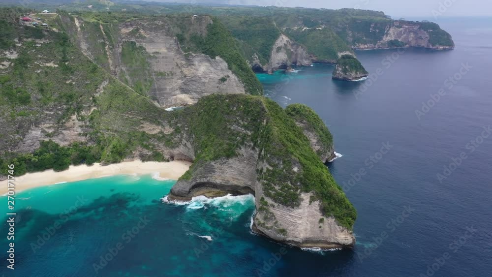 Aerial drone video of beautiful exotic beach with green rocks, Kelingking beach, Nusa Penida, Bali, Indonesia, 4K 