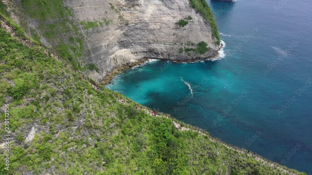 Aerial drone video of beautiful exotic beach with green rocks, Kelingking beach, Nusa Penida, Bali, Indonesia, 4K 