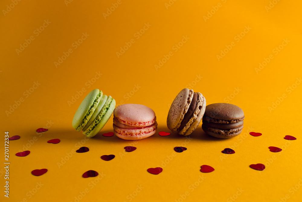macaroon arranged in beautiful composition on a yellow background macaroon arranged in beautiful composition on a yellow background