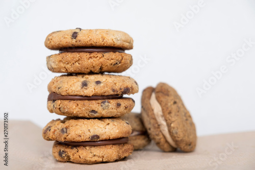 Stack of delicious hazelnut or almond sandwich biscuits with chocolate, ganache and gianduja filling. Baci di dama (Ladys kisses) - italian cookies from Piedmont.