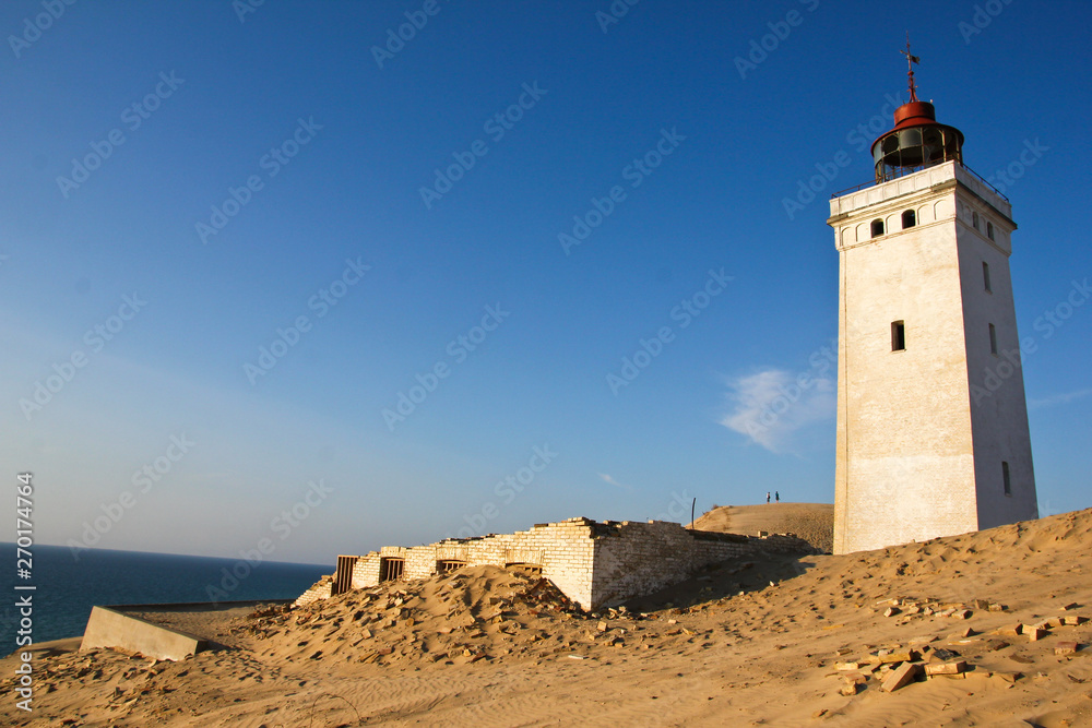 A lonely abandoned lighthouse Rubjerg Knude Fyr waiting for the sea to come and for its doom.
