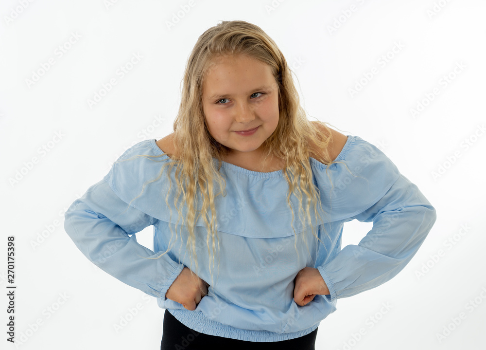 Pretty little girl with a angry facial expression looking mad at the camera. Human emotions