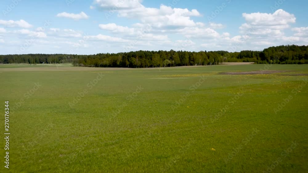Aerial drone camera shot of beautifully green summertime meadow. Aerial drone camera shot of beautifully green summertime meadow.