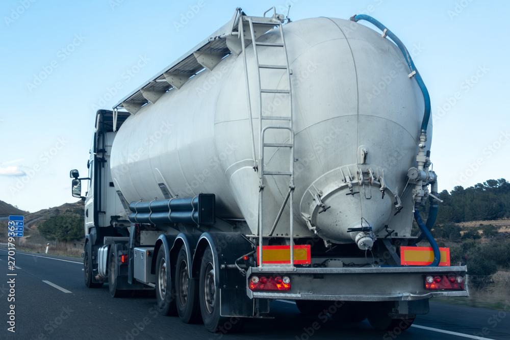 Freight truck traveling and transporting goods on the road to reach the destination