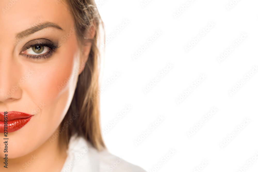 Naklejka premium Half portrait of beautiful young woman with makeup on white background