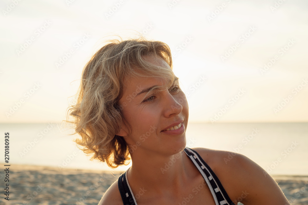Natural portrait of a smiling blonde woman near the sea Natural portrait of a smiling blonde woman near the sea