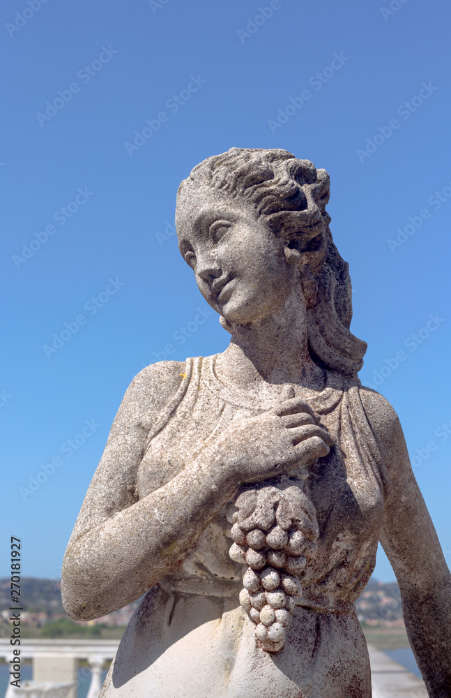 Sculpture of a girl with a bunch of grapes
