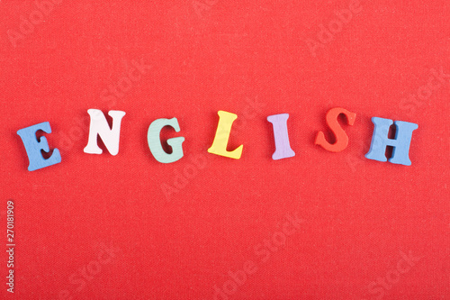 English word on red background composed from colorful abc alphabet block wooden letters, copy space for ad text. Learning english concept.