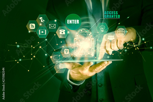 Businessman holding tablet with hologram of the concept of data protection, access granted
