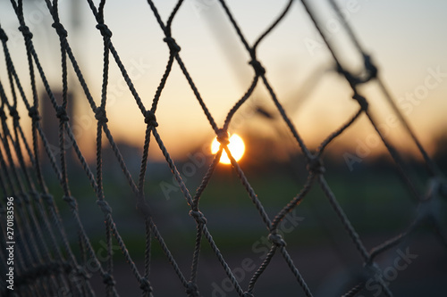 Sunset behind rope