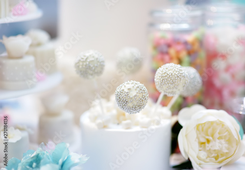 Anniversary/wedding delicious sweet dessert - cupcakes, marshmallow, vanilla cake pops. Stylish sweet table.