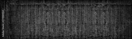Old black concrete wall wide texture. Dark gray cement gloomy background