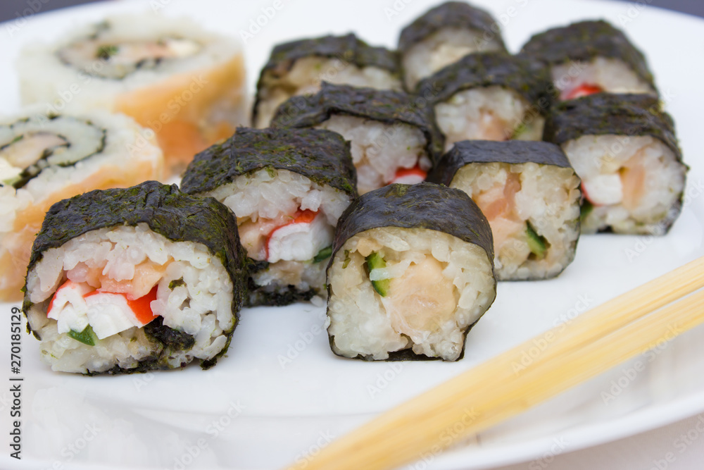 Japanese cuisine, rice sushi and fish - closeup Japanese cuisine, rice sushi and fish - closeup