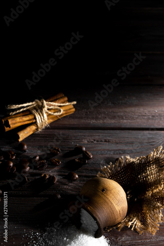 Small barrel with sugar on a wooden background