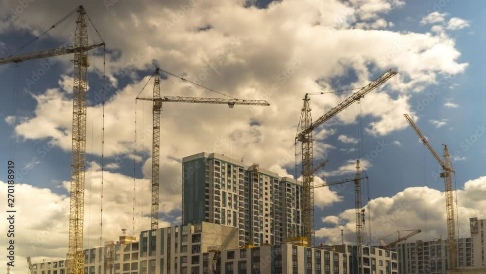 Cranes working day and night on construction of the housing estate in former industrial zone, time lapse