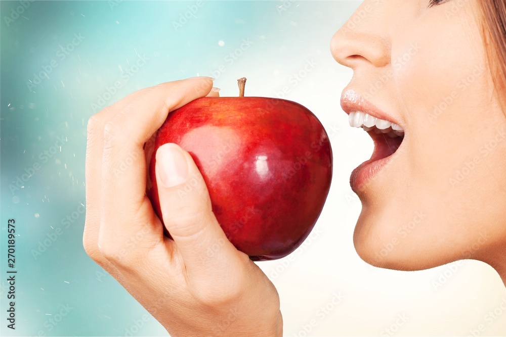 Young woman holding fresh apple on white background Young woman holding fresh apple on white background